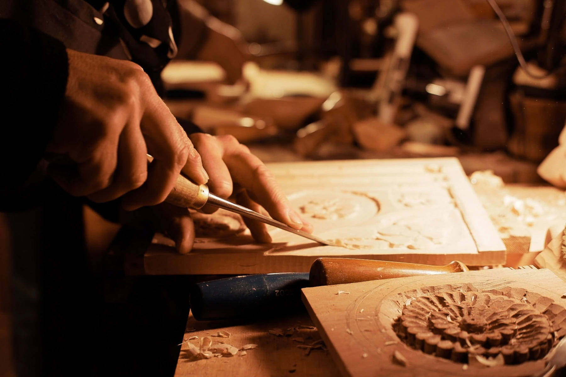 Artisan carving wood by hand